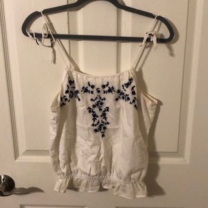 Floral embroidery.  White top.